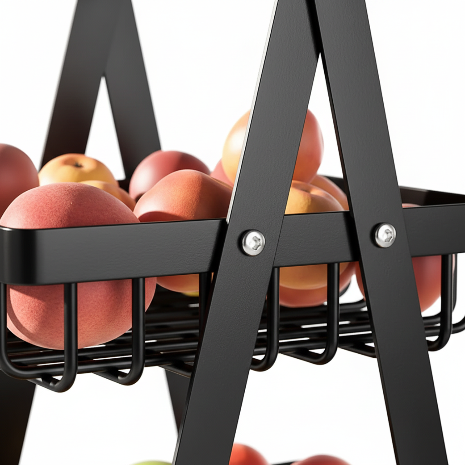 Close-up of a black metal fruit basket organizer holding several red and yellow apples, shown against a white background.