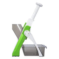 Green and white kitchen tool with a metallic bowl on a white background