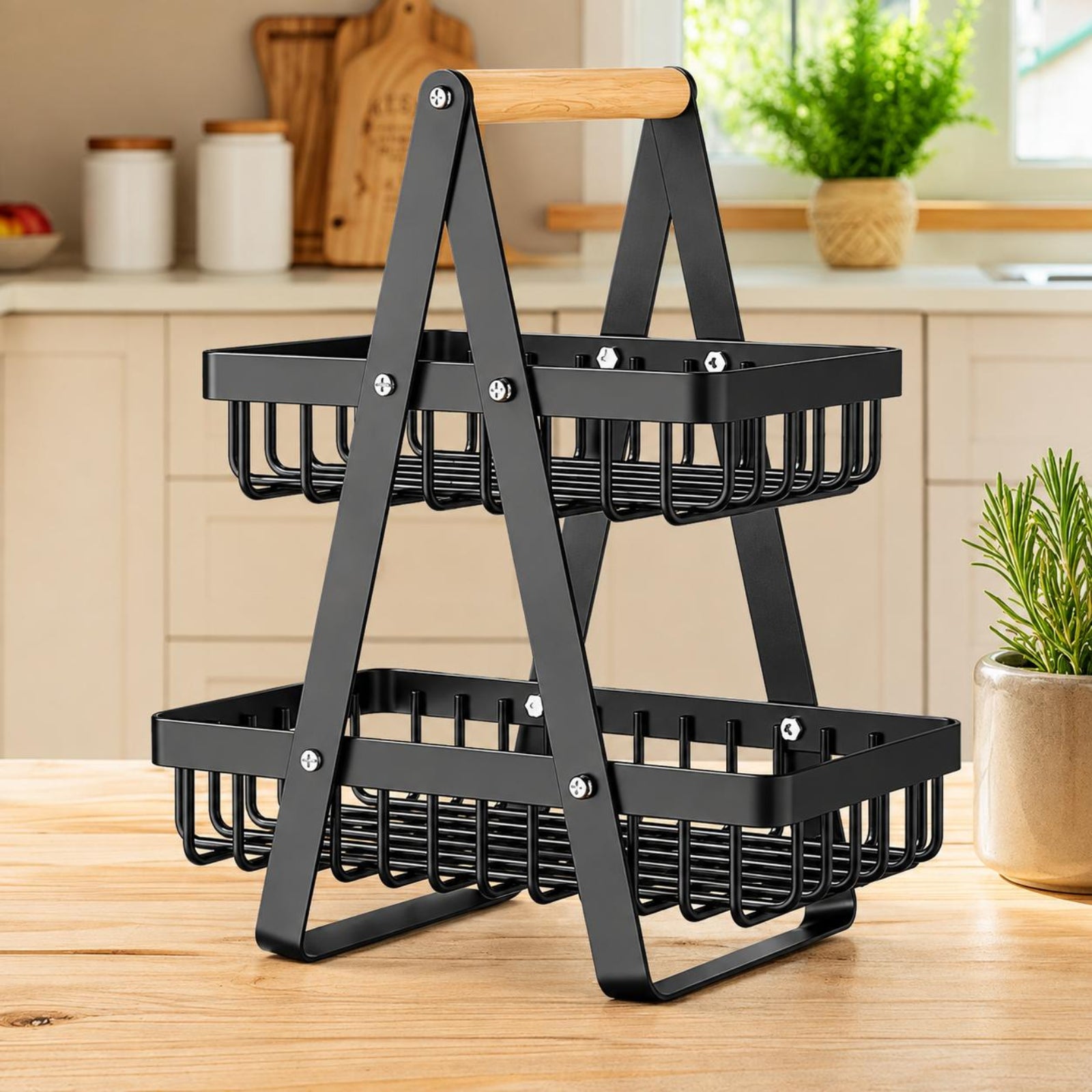A two-tier black metal wire basket organizer with a wooden handle, shown on a wooden countertop in a kitchen setting.