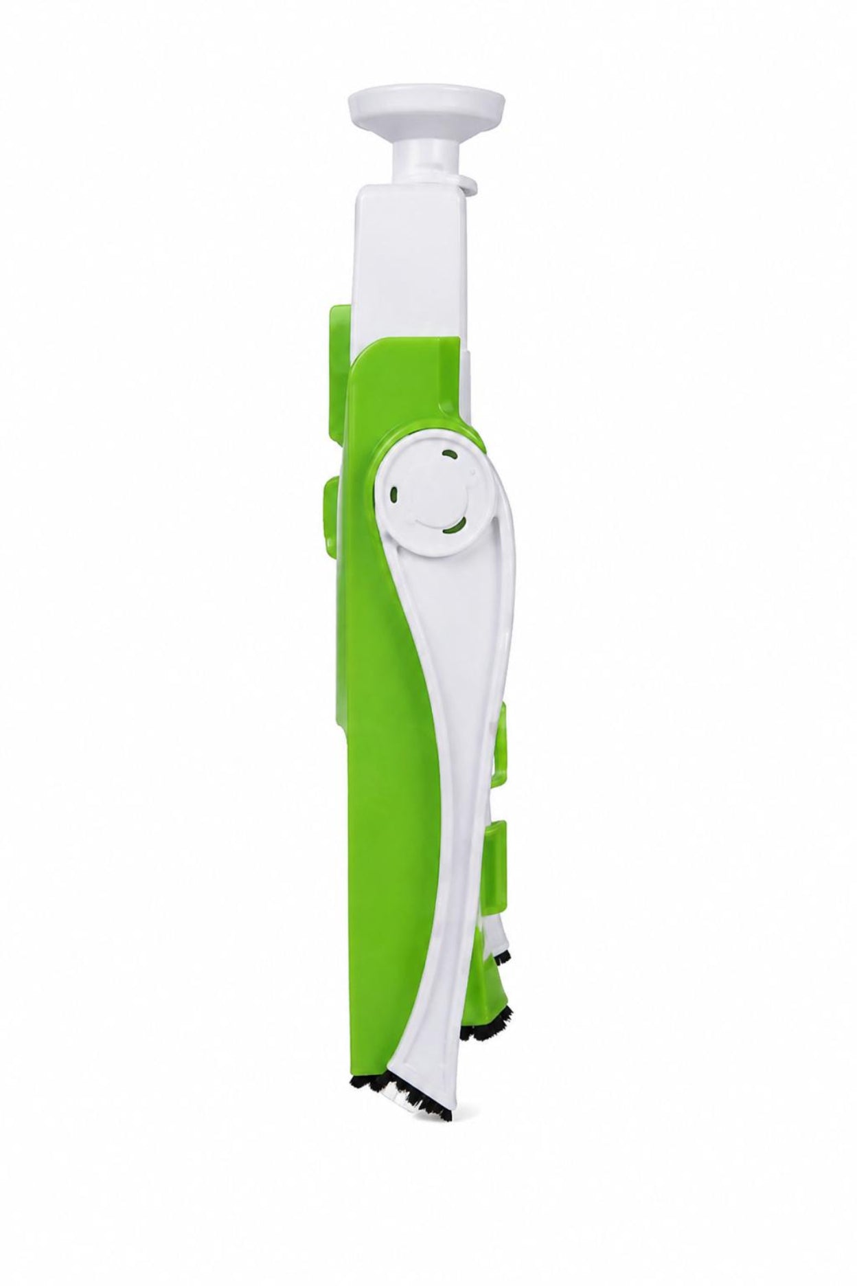A green and white plastic kitchen utensil, likely a peeler or slicer, shown vertically against a plain white background.