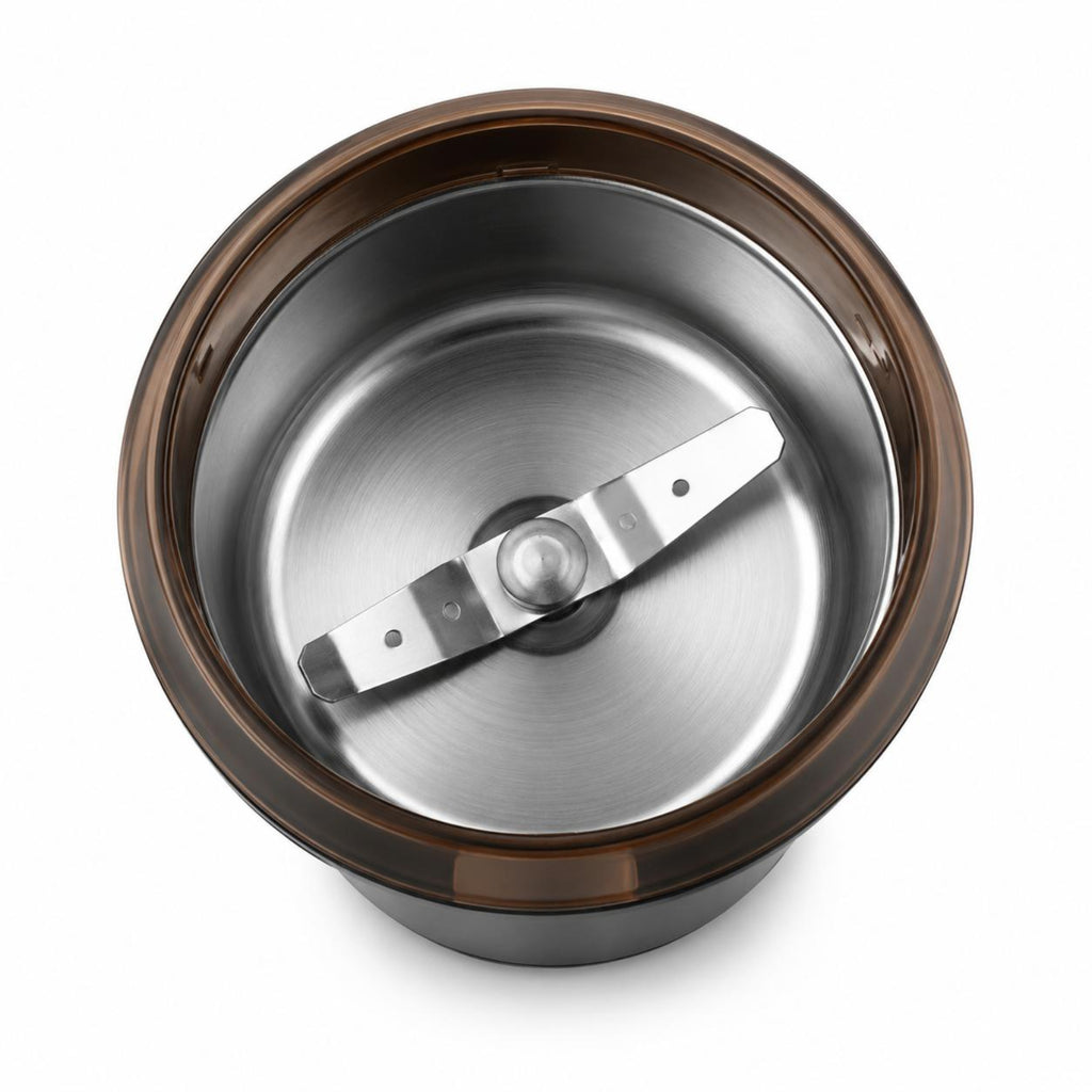 Top-down view of a stainless steel blender jar with a dark brown translucent plastic lid and a silver metal blade, isolated on a white background.